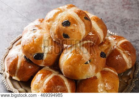 Freshly Baked Easter Cross Buns With Sultanas Closeup On The Plate On The Table. Horizontal