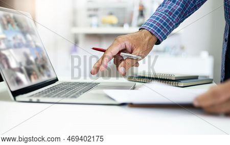 Asian Businessman Using Laptop Computer. Businessman Reviewing Business Contract And Working Or Meet