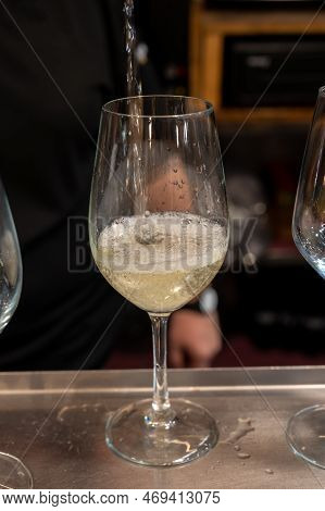 Pouring Of Txakoli Or Chacolí Slightly Sparkling Very Dry White Wine Produced In Spanish Basque Coun
