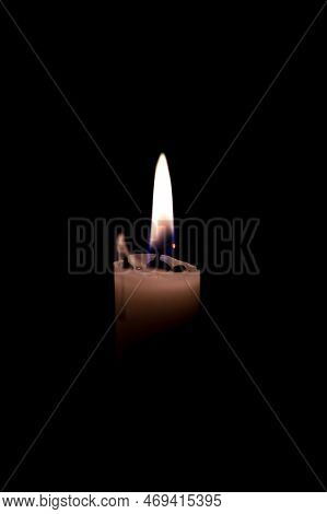 One Burning Candle In Dark Black Room