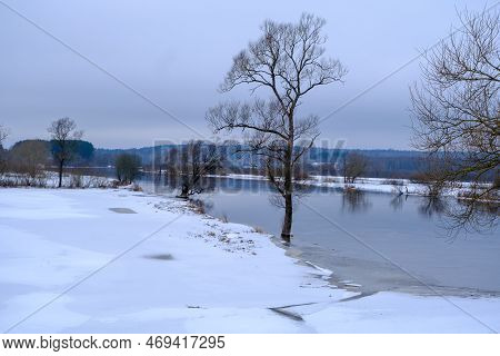 River Aiviekste In Vidzeme, Latvia In Winter Time. High Water Level In The River, Dark January Day.