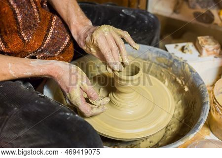 Professional Male Potter Making Ceramics On Pottery Wheel In Workshop, Studio. Close Up View Of Pott