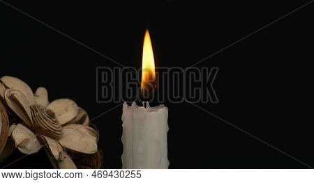 Banner Size Image Of Burning Candle And Flowers Against A Black Background With Free Copy Space For 