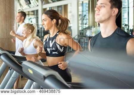 Young People Running On A Treadmill At Gym.
