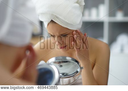 Young Woman Sits In The Bathroom In Front Of The Makeup Mirror And Does Cosmetic Procedures. Beautif