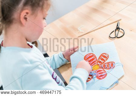 Little Girl Learning How To Sew With Sewing Craft Kit For Kids.