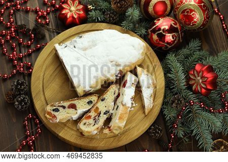 Traditional Stollen With Decoration On Wooden Background