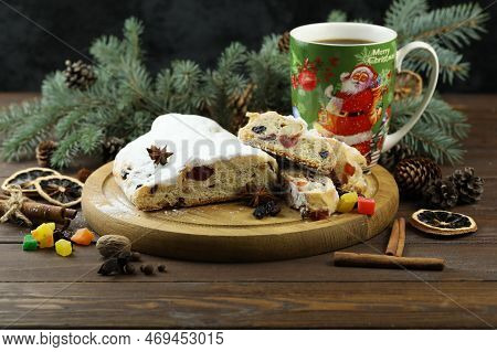 Traditional Stollen With Decoration And Cup Of Coffee On Wooden Background