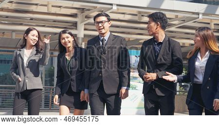 Group Of Business People Asian Team Partners Walking In City Happy Together. Leader Executive Men St