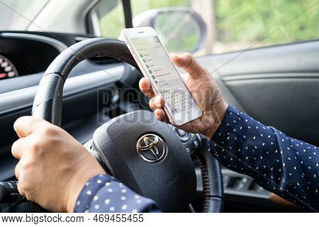 Bangkok, Thailand, July 1, 2022 Holding Iphone In Toyota Sienta Car To Communication With Family And