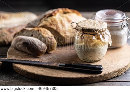 Rye Sourdough Ripened In A Jar Together With Fresh Bread On A Cutting Board