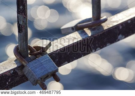 Close Up Of A Lovelocks Hanging On Bridge Against Water