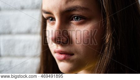 Kid Crying With A Tear On Cheek. Little Child Cry. Portrait Of Kid Wipes Tears. Close Up Kid Crying 