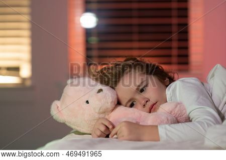 Cute Boy Trying To Fall Asleep With Toy Teddy Bear. Child Go To Sleep In The Night In The Bedroom. C