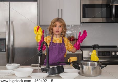 Cleaning At Home. Child Helping With Household, Wiping Dishes In Kitchen. Child Helper Housekeeping.