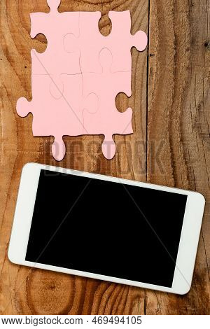 Mobile Phone With Important Message On Desk With Empty Pink Puzzels And Notes. Cellphone Screen With