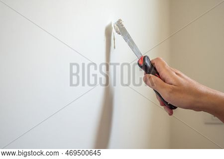 Man Repairing Crack White Wall With Spatula