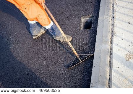 Above View On Worker That Uses Rake To Level, Set Up Layer Of Fresh Tarmac To Right Measures, Flatte