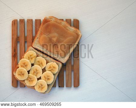 Toast With Applesauce And Banana Slices On White Background. Top View. Diet Snack While Diarrhea Or 