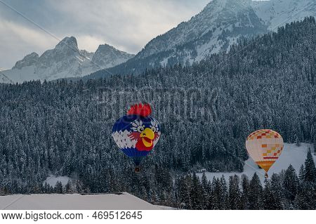 Hot Air Balloon. Two Hot Air Ballooning Flying In The Sky. Chateau-d'oex,vaud, Switzerland.
