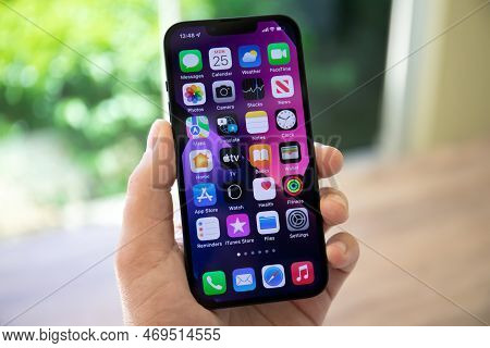 Alanya, Turkey - April 25, 2022: Man Hand Holding Iphone 13 With Home Screen Ios 15 On The Screen.