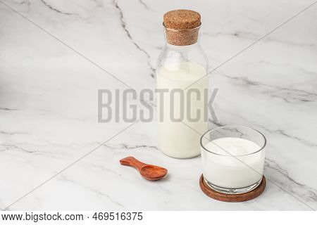 A Bottle Of Milk And Glass Of Yogurt, Kefir, Fermented Milk, Probiotic Cold Fermented Dairy Drink. T