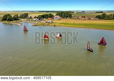 Aerial From Traditional Dutch Wooden Boats At The Ijsselmeer Near The Harbor From Laaxum In Frieslan