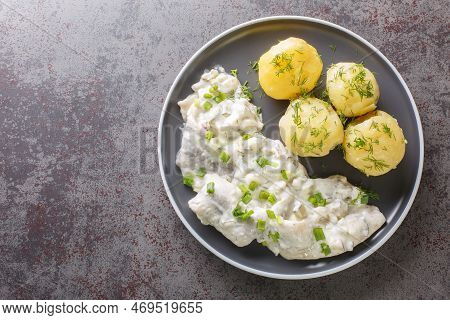 Herring With Creamy Sauce With Apples, Pickles And Onions With Boiled Potato Garnish Close-up In A P