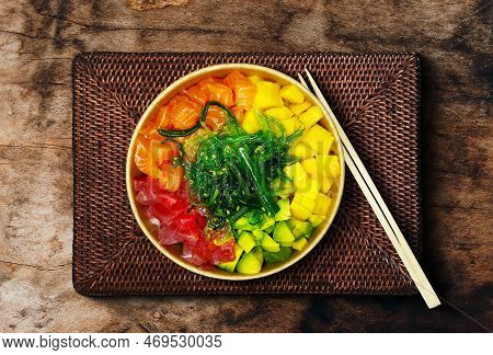 Japanese Poki With Sashimi Salmon, Avocado, Udon, Wakame Seaweed, Tuna On The Old Rusty Wood Table.
