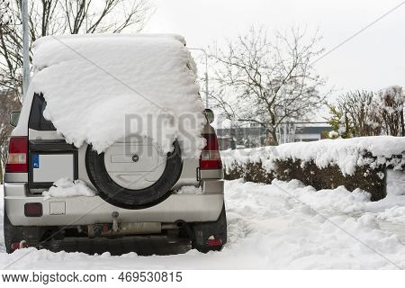 Off-road Car Of Japanese Production Under A Lot Of Snow. The Car Is Parked In A Neighborhood Parking
