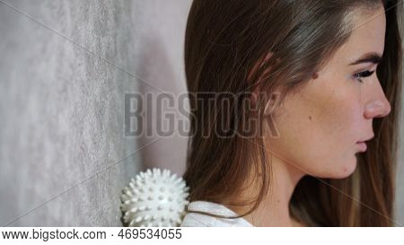 Athletic Slim Caucasian Woman Doing Thigh Self-massage With A Massage Ball Indoors. Self-isolating M