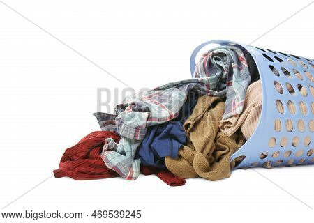 Overturned Laundry Basket Full Of Clothes On White Background, Closeup