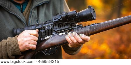 Hunter Or Ranger With A Professional, Nightvision Hunting Gun And Hunting Form To Hunt In An Autumn 