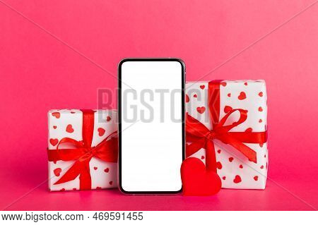 Mobile Phone With Blank Screen On Colored Background With Hearts, Calendar And Gift Box, Valentine D