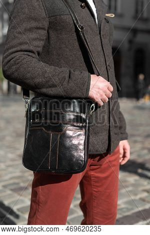 Close-up Photo Of Black Messanger Leather Bag On Mans Shoulder