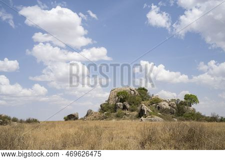 An Inselberg In The African Savanna In Tanzania, On A Partially Cloudy Day.