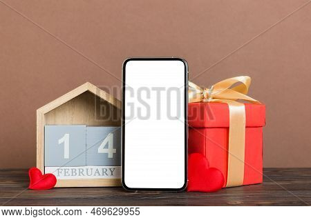 Mobile Phone With Blank Screen On Colored Background With Hearts, Calendar And Gift Box, Valentine D