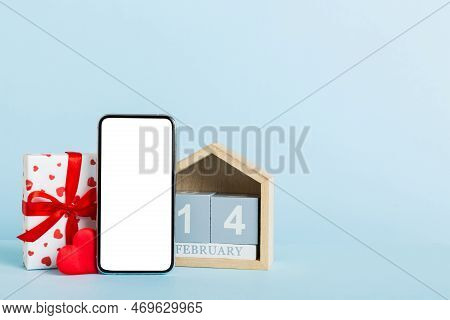 Mobile Phone With Blank Screen On Colored Background With Hearts, Calendar And Gift Box, Valentine D