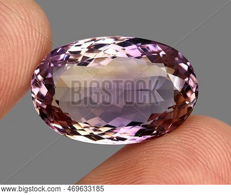 Natural Gemstone Bicolor Ametrine On A Gray Background