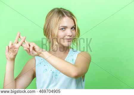 Young Happy Winsome Caucasian Blond Girl In Blue Dress Posing In While Holding Hands In Hashtag Gest