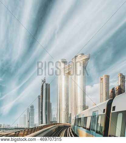 Monorail Subway Train Rides Among Glass Skyscrapers In Dubai. Traffic On Street In Dubai. Cityscape 