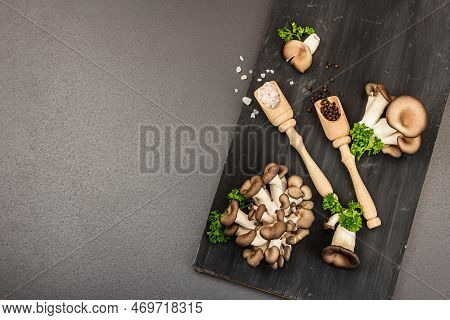 Delicious Organic Oyster Mushrooms With Spices And Fresh Parsley On Wooden Cutting Board