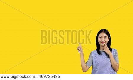 Asian woman pointing finger inviting click here, It is recommended to follow this direction or click