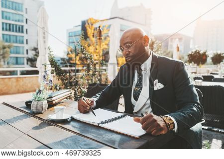 A Confident Mature Hairless African American Man Entrepreneur In A Tailored Formal Business Suit And