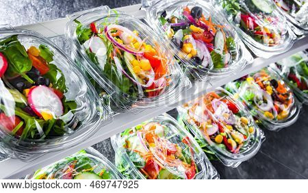 Boxes With Pre-packaged Vegetable Salads In A Commercial Fridge