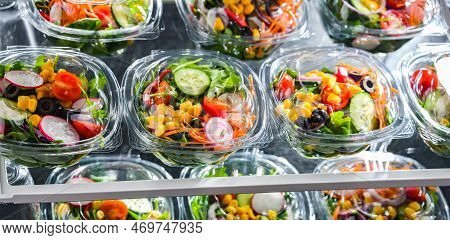 Boxes With Pre-packaged Vegetable Salads In A Commercial Fridge