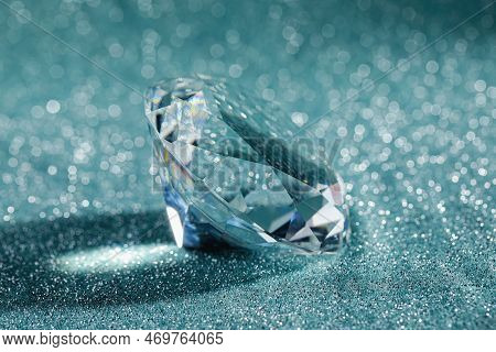 Beautiful Dazzling Diamond On Shiny Glitter Background, Closeup. Precious Gemstone