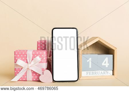 Mobile Phone With Blank Screen On Colored Background With Hearts, Calendar And Gift Box, Valentine D
