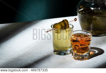 Pickleback, Alcoholic Cocktail Made From Cucumber Pickle And Whiskey In Small Shot Glasses. Hard Lig