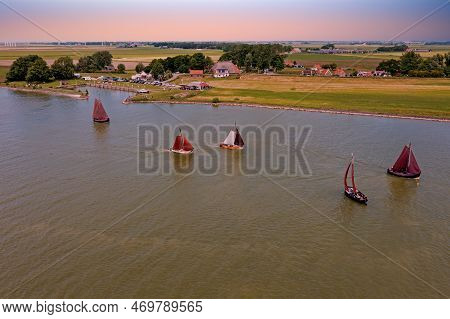 Aerial From Traditional Dutch Wooden Boats At The Ijsselmeer Near The Harbor From Laaxum In Frieslan